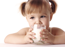 Kleines Mädchen mit Milchglas