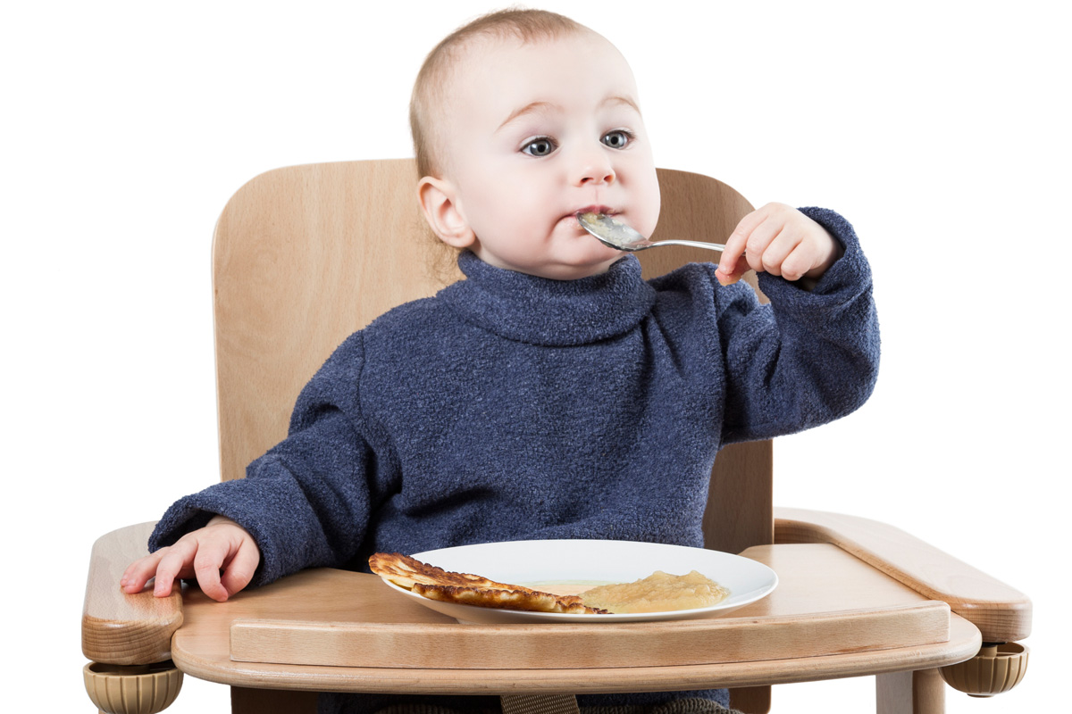 Baby isst Pfannkuchen mit Apfelmus