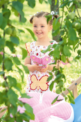 Mädchen spielt im Garten mit Spielzelt